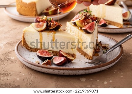 Fall cheesecake with figs, pecan nuts and maple syrup poured over Royalty-Free Stock Photo #2219969071