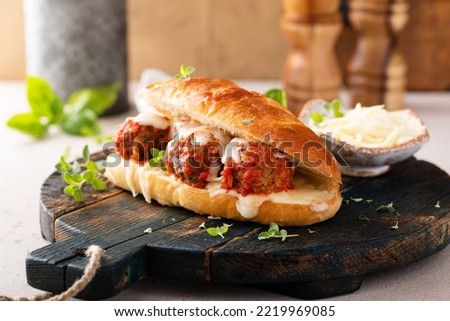 Meatball sub sandwich with marinara and mozzarella and fresh herbs Royalty-Free Stock Photo #2219969085