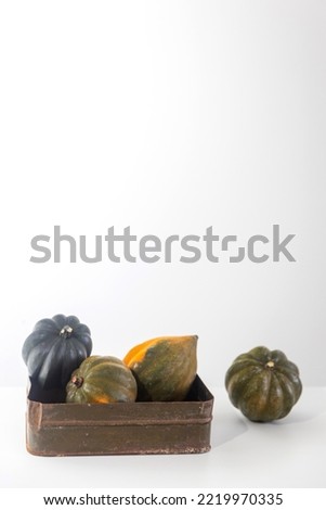 Natural small pumpkins, orange candles on a white table, Halloween decorations. Place for text