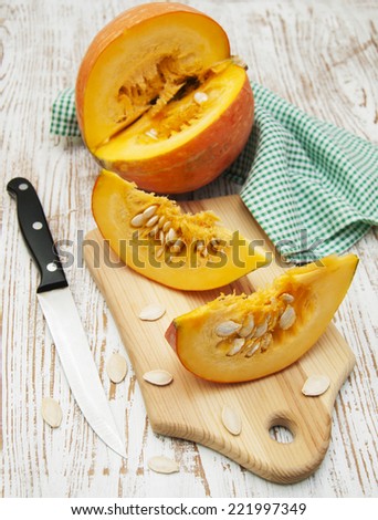 Plate with sliced pumpkins on kitchen table