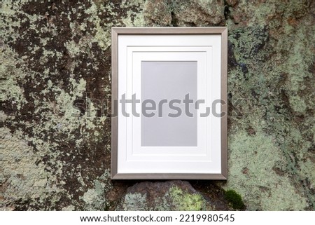 Picture frame on rock background. Empty frame with copy space and passe partout, natural background, art, information, sign concept