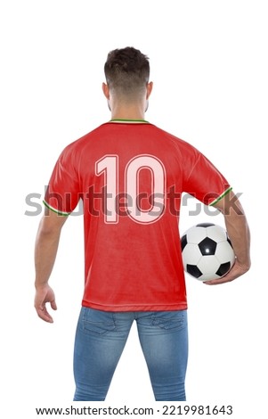 Soccer fan man with number ten in red jersey the national team of IR IRAN with ball in hands on white background. Royalty-Free Stock Photo #2219981643