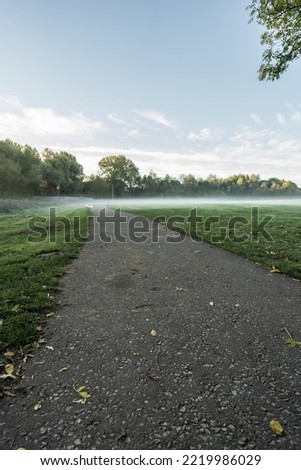 Nantwich Mill Island pathway, foggy autumnal sunrise. Travel and park landscape concept illustration.