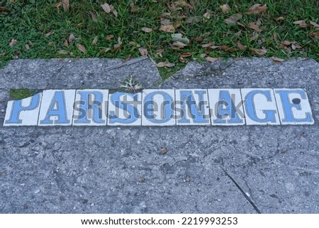 Vintage Sidewalk Tile Inlay that reads "Parsonage" in front of a pastor's house  in Uptown New Orleans Neighborhood	