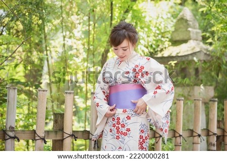 A woman in a yukata who repairs her obi Royalty-Free Stock Photo #2220000281