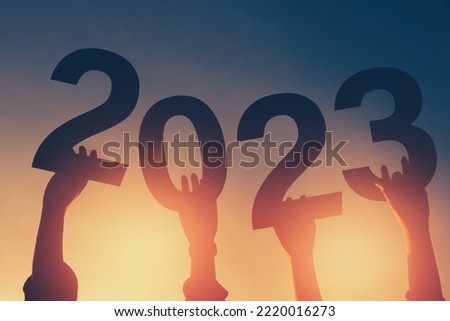 Happy new year 2023 background new year holidays card with bright sunlight, with arms raised new year 2023.
