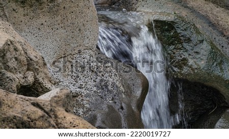 Long exposure photo of water flow on the rocky river
