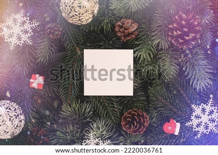 Christmas tree branches with paper card note. Flat lay. Nature New Year concept.