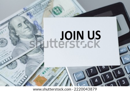Join Us text on business card on the background of the calculator on the table with dollar bills