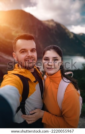 Selfie of a young loving couple traveling. Concept of outdoor adventure during vacation.