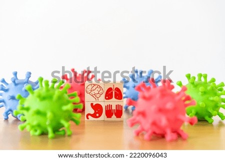 Healthcare. body parts human icon on wooden cube block stack on white background and facked colors plastic virus shape, vaccination, laboratory, virus prevention, health, medical technology 