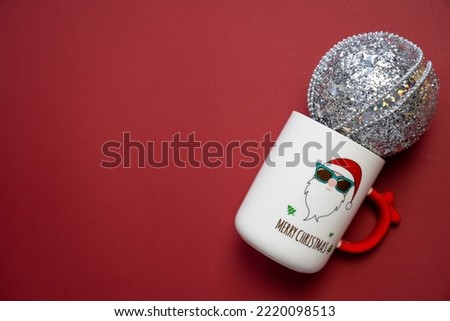 merry Christmas and happy new year, festive white cup with santa claus print, mug silver sparkly bauble, copy space, holiday celebration