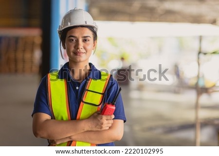 Portrait Indian woman worker supervisor smart confident look with engineer safety suit work in large factory warehouse industry Royalty-Free Stock Photo #2220102995