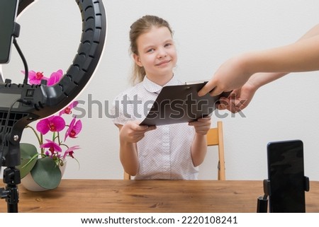 girl blogger receives a script from an assistant