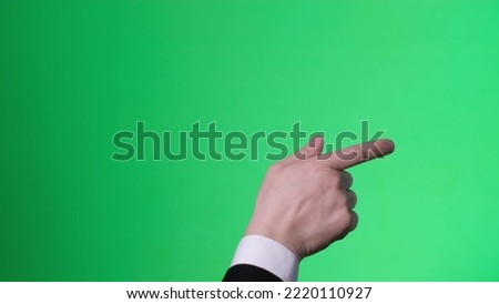 Male hand gestures on green screen: pointing or tapping on the screen, chromakey. 4k video