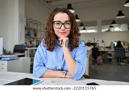 Confident young business woman leader, coach, hr manager looking at web camera having online job interview, remote video conference call or leading work webinar sitting in office. Portrait. Royalty-Free Stock Photo #2220115765