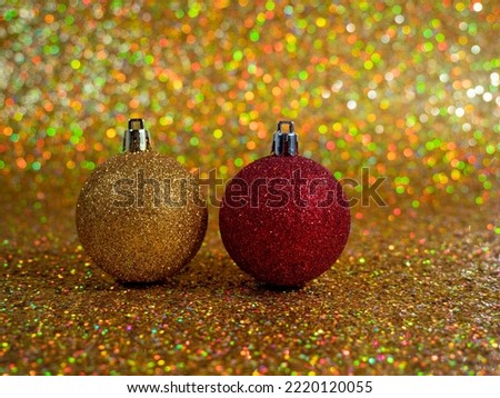 Christmas balls on a golden background. Christmas decoration with beautiful bokeh. Multicolored balls.