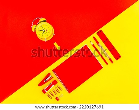 Set of red Stationery, notepad, ruler, stapler, red pencil, red pen on yellow background and yellow alarm clock