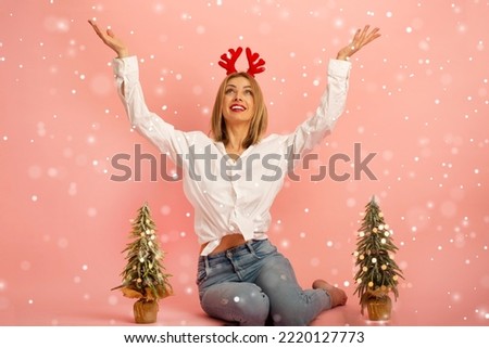Girl christmas theme.Blonde girl celebrating christmas.Snow falling