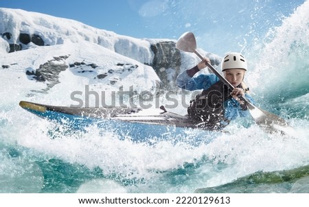 Woman in a kayak sails on a mountain river. Whitewater kayaking, extreme kayaking. Royalty-Free Stock Photo #2220129613