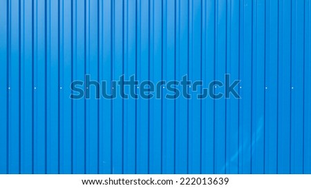 blue painted iron fence of corrugated long with screws Royalty-Free Stock Photo #222013639