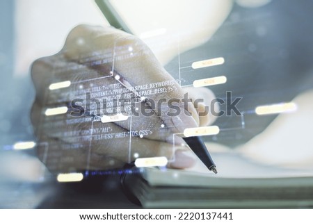 Multi exposure of abstract software development hologram and man hand writing in notebook on background, research and analytics concept