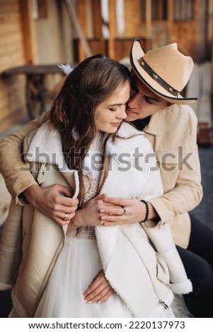 Loving couple on a ranch in the west in winter Royalty-Free Stock Photo #2220137973