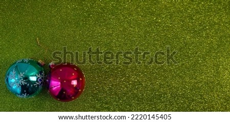 green christmas background with fir tree branch and christmas balls and toys                             