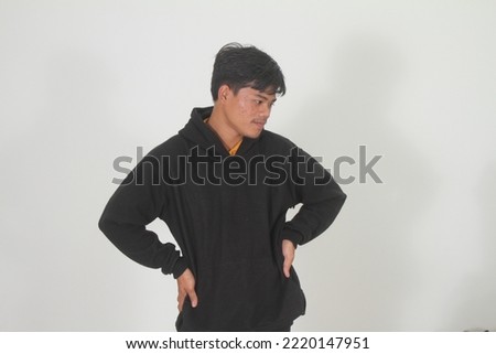 Confident Indonesian man wearing a hoodie is thinking