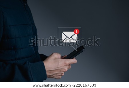 Businessman hand holding use smartphone with new email alert sign icon pop up to send or read email. Communication business technology concept. connection message to global letters. receive newsletter