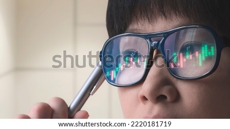 Female crypto Trader Analyzing online trading stock market Chart with reflection on Glasses surface, close up with copy space Royalty-Free Stock Photo #2220181719