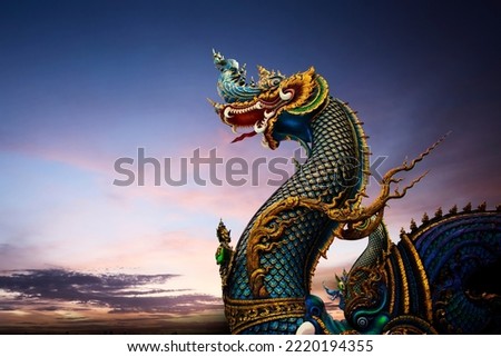 Wat Rong Sua Ten, Chiang Rai, Thailand - King of Nagas, Great Naga on purple sky found in the buddhism temples Royalty-Free Stock Photo #2220194355