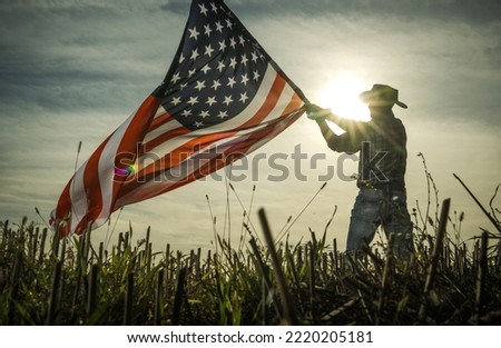 Man Shows Love of Country by Waving American Flag. Patriotic Cowboy.