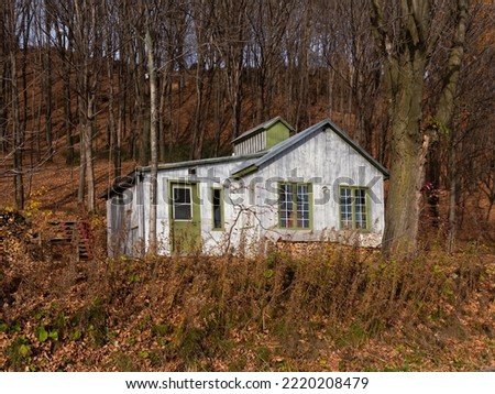 Small sugar shack in maple trees woods seen during a fall afternoon on King’s Road, St-Augustin-de-Desmaures, Quebec, Canada Royalty-Free Stock Photo #2220208479