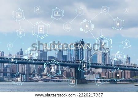 Brooklyn and Manhattan bridges with New York City financial downtown skyline panorama at day time over East River. Decentralized economy. Blockchain, cryptography and cryptocurrency concept, hologram