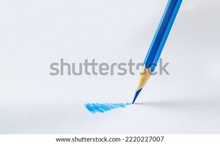 Blue pencil on a white background Royalty-Free Stock Photo #2220227007