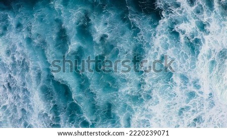 Beautiful texture of big power dark ocean waves with white wash. Aerial top view footage of fabulous sea tide on a stormy day. Drone top shot breaking surf with foam in Indian ocean. Big swell in Bali