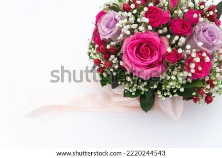 winter wedding bouquet with rose flowers lies on the snow