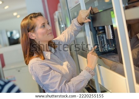 portrait of woman buying a new appliance Royalty-Free Stock Photo #2220255155