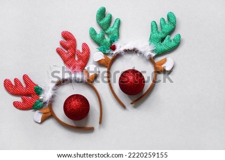 funny christmas reindeer ears. funny headbands with deer ears and red christmas balls instead of a nose