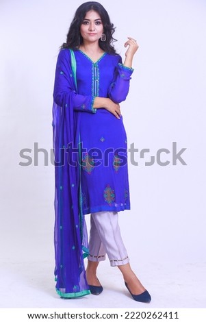 Beautiful Pakistani Woman in Blue traditional embroidery shalwar kameez dress. Fashion Concept