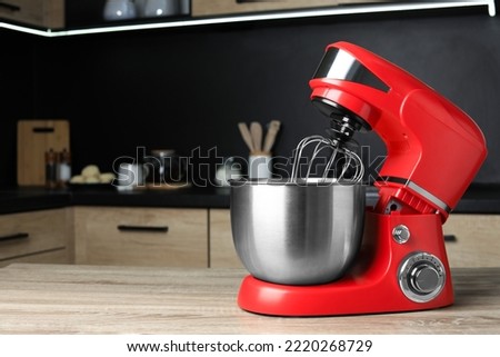 Modern stand mixer on wooden table in kitchen, space for text. Home appliance Royalty-Free Stock Photo #2220268729