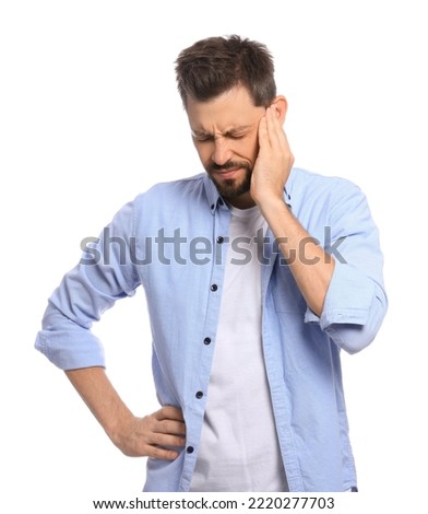 Man suffering from ear pain on white background Royalty-Free Stock Photo #2220277703