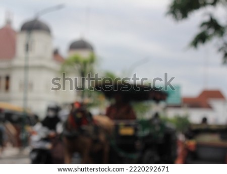 De Focused City with Horse-drawn Carriage in Yogyakarta. De Focused Abstract Delman in Yogyakarta. De Focused City Photo for Bokeh Background. Defocus City. Defocus Street. Bokeh Photo. Royalty-Free Stock Photo #2220292671