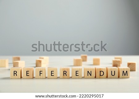 Word Referendum of wooden cubes on white table against light grey background. Space for text Royalty-Free Stock Photo #2220295017