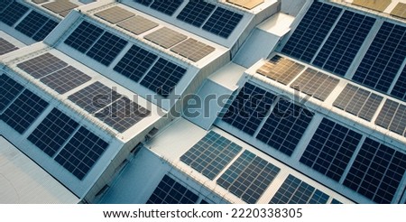 Solar cell on the roof of a large industrial factory. Solar roofs are generating renewable energy for the industry. The goal is to reduce the cost of electricity.