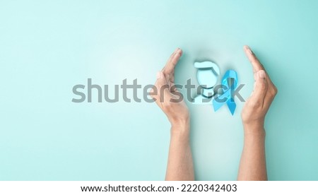 hand cover sign symbol of man iconic and light blue ribbon awareness on blue background for Prostate Cancer Day
