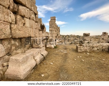 Amman, Jordan, November 2019 - A stone building with a large rock