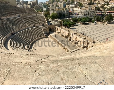 Amman, Jordan, November 2019 - A large building with Theatre of Dionysus in the background