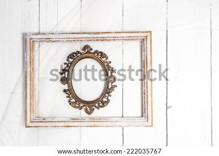 Vintage Shabby chic oval photo frame with rectangular frame for wedding bridal photo on a white wooden background